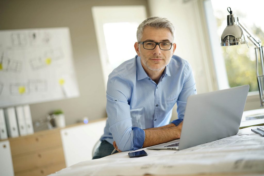 Portrait of architect looking at camera in office Portrait of architect looking at camera in office